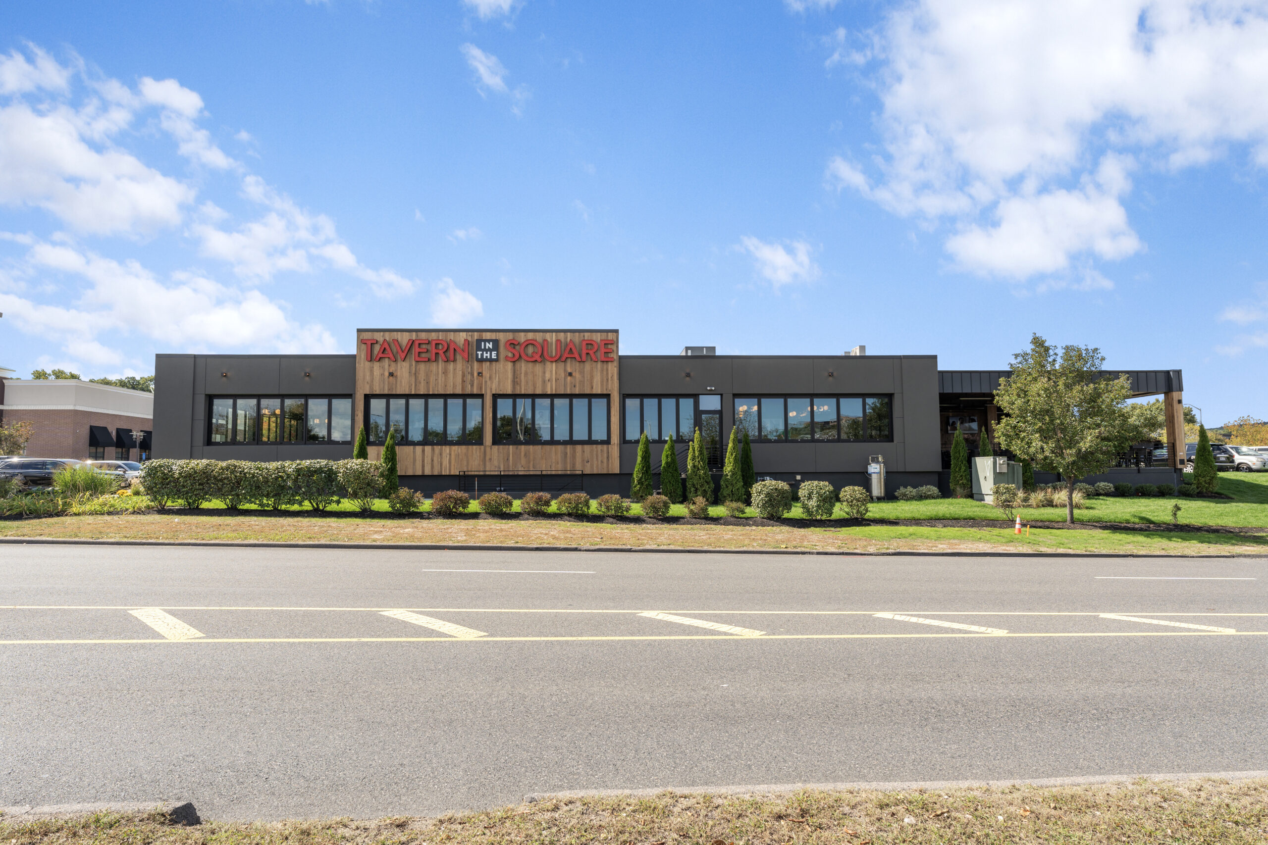 A modern building with large windows and a sign reading 
