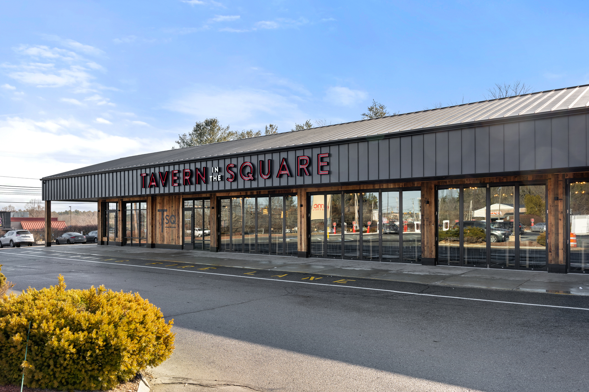 A single-story Bar & Restaurant with large glass windows and a sign reading 